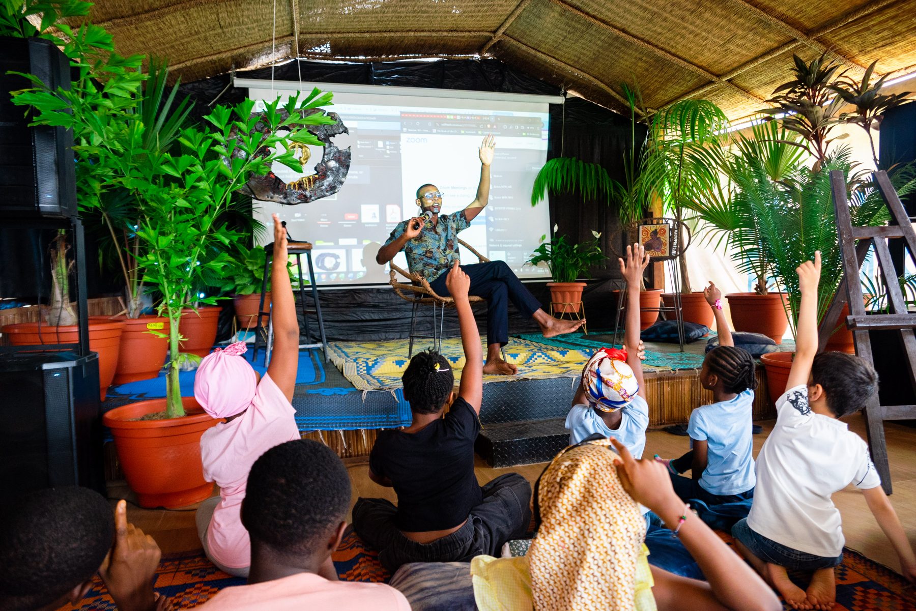 Pupils raising their hands during a CCAIE climate learning session