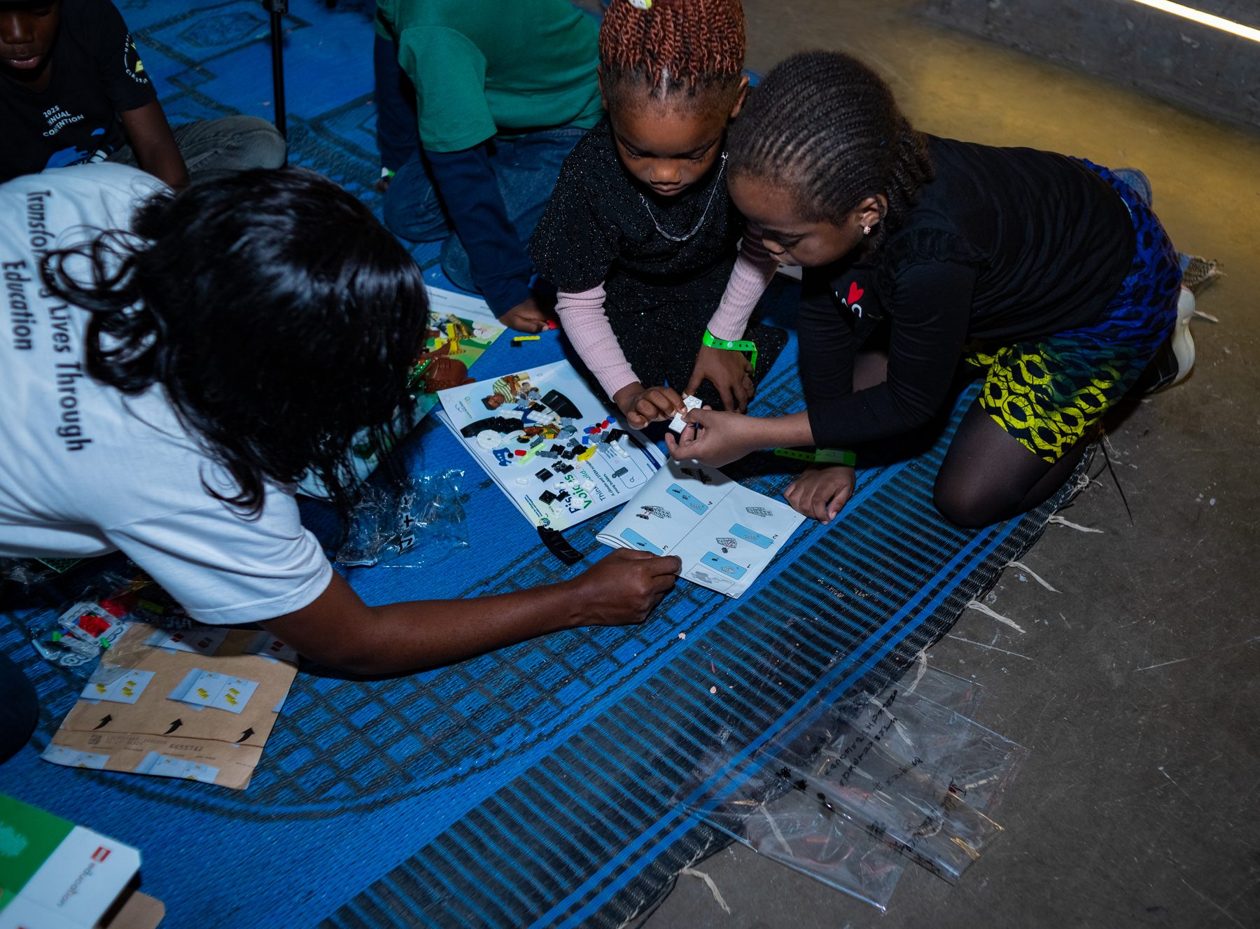 Children assembling a project during a Rising Voices session in Abuja