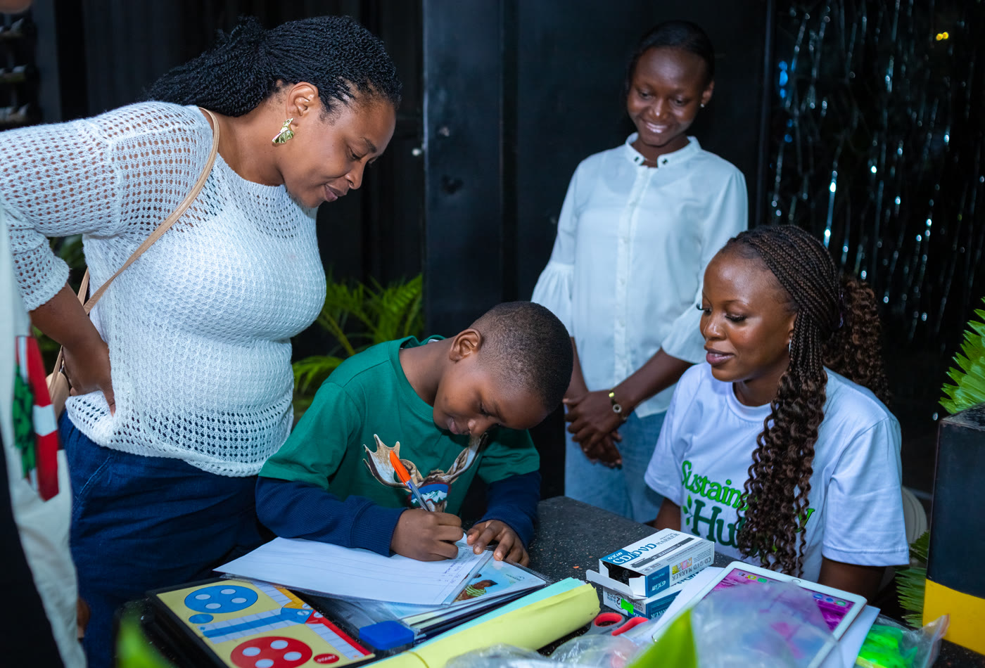 A CCAIE educator and teacher guiding a pupil through a climate learning exercise
